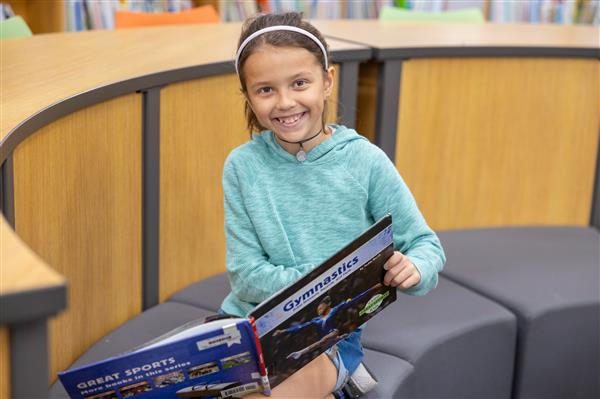 girl smiling with book
